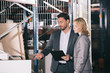 © LIGHTFIELD STUDIOS - handsome businessman pointing with finger at construction materials while standing near businesswoman