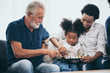 © chokniti - Happy people family concept laugh and have fun together with three different generations ages