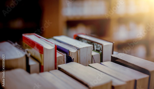Stack of books in the library and blur bookshelf background Tableau sur Toile