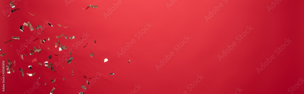 view of golden christmas confetti isolated on red with copy space - obrazy, fototapety, plakaty 