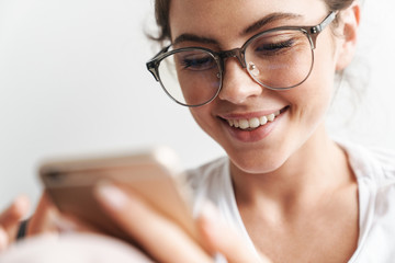 Sticker - Image closeup of concentrated woman smiling and using cellphone