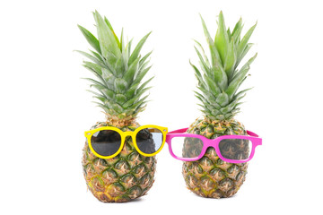 Pineapples with glasses isolated on white background. Juicy fruit