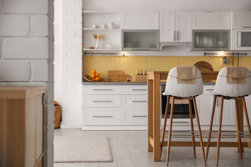 Sticker - Modern kitchen interior with stylish wooden table