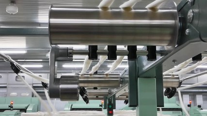 Canvas Print - Machinery and equipment in the workshop for the production of thread. Roller mechanism in textile factory. Close-up