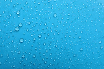  Water drops on light blue background, top view