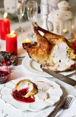 Canvas Print - pieces of turkey with cranberry sauce on a plate on Christmas Day. turkey for Christmas. New Year's and Christmas table with turkey in white tones.