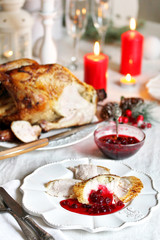 Sticker - pieces of turkey with cranberry sauce on a plate on Christmas Day. turkey for Christmas. New Year's and Christmas table with turkey in white tones.