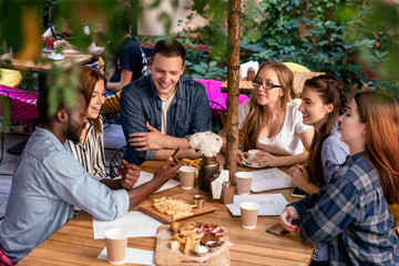 Delicious food on the table of a friendly meeting of best friends in the cozy restaurant outdoors