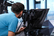 © New Africa - Professional video camera operator working in studio