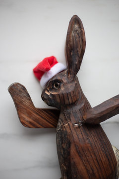 Easter composition on white rustic marble table with decorative wooden bunny