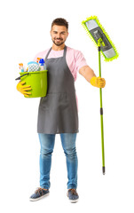 Poster - Male janitor with cleaning supplies on white background