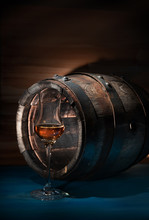A Glass Of Whiskey Beside An Old Oak Barrel