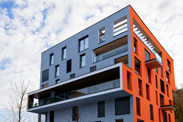 Poster - Colorful Modern residential apartment and flat building exterior in Salzburg, in Austria. New luxury house and home complex of blue and red color. City Real estate property and condo architecture.