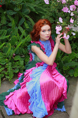 Wall Mural - beautiful red-haired girl in arranger where azalea blooms in a colorful flying dress