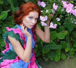 Wall Mural - beautiful red-haired girl in arranger where azalea blooms in a colorful flying dress