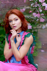 Wall Mural - beautiful red-haired girl in arranger where azalea blooms in a colorful flying dress