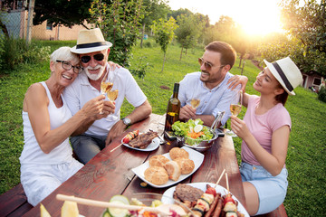 Poster - Family eating outdoors