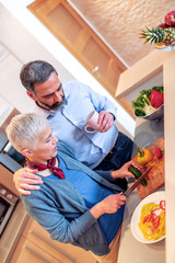 Wall Mural - Senior couple cooking together at home