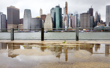 Panoramic View Of Manhattan Skyscrapers Shot From Brooklyn Bridge Park On A Rainy Summer Day. New York, Usa