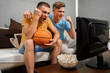 © phoenix021 - Teenagers watching basketball game on TV and cheering