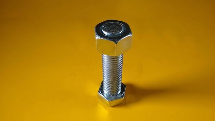 Wall Mural - Nut that is screwed into its respective hex head screw, stop motion animation