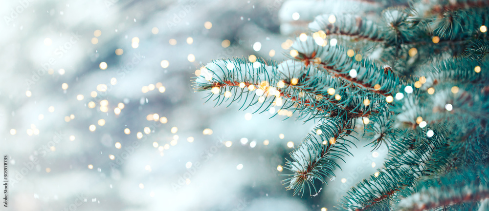 Christmas tree outdoor with snow, lights bokeh around, and snow falling, Christmas atmosphere. - obrazy, fototapety, plakaty 