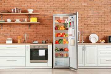 Canvas Print - Open big fridge with products in interior of kitchen