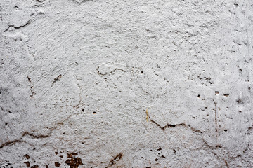 Texture of a concrete wall with cracks and scratches which can be used as a background