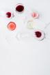 Glasses with different wine bordeaux, red, rose and white on white background. Beautiful wine variety concept.