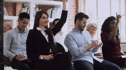 Poster - Female training participant raise hand up ask question at conference