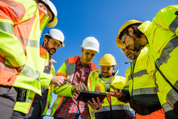 Engineers and workers assesing wastewater plant