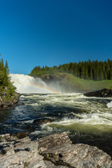  The waterfall Tannforsen in Sweden with a rainbow in the water spray