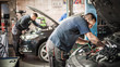 Car mechanic repairer service technician checks and repairs auto engine