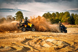 Fototapeta  - Racing powerful quad bike on the difficult sand in the summer.