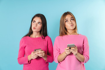 Poster - Photo of thinking nice women typing on cellphones and looking aside