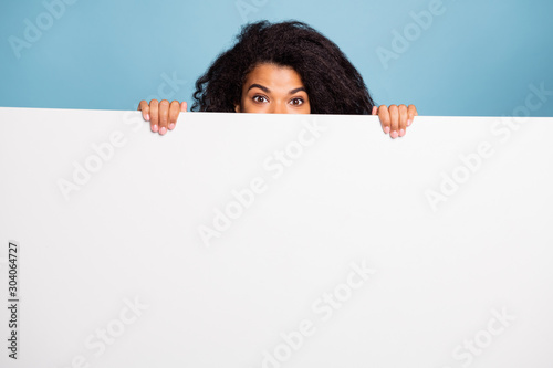 Fotomural Photo of curly wavy cute cheerful positive brown haired presenting you informati