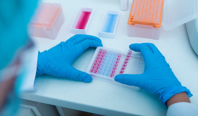 Poster - Woman collecting colored samples in box for testing them