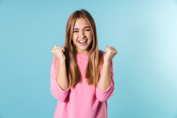 Wall Mural - Photo of happy blonde woman looking at camera with winner gesture