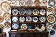 Traditional Italian accent plates,glass,teapot, and dinnerware sets decoration displayed on a wooden rack and wall
