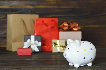 Wall Mural - Christmas shopping concept. Piggy bank and Christmas gifts