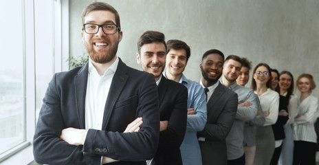 Young diverse business team posing with crossed arms