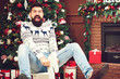 © volurol - Christmas bearded guy with shocked facial expression at party. Happy christmas holidays. Excited man screaming wow omg while sitting on wooden christmas horse