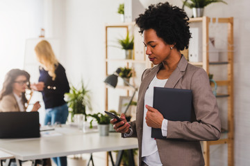 Wall Mural - Portrait of African American Business Woman standing at Office