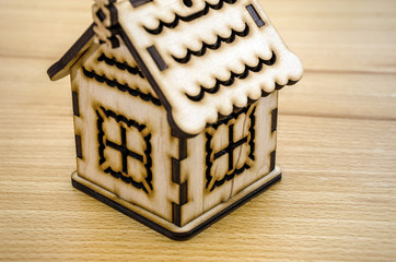 Poster - wooden, toy house on a wooden background.