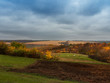 © Светлана Горбань - Autumn rural landscape. Low cumulus clouds before the rain. Trees and shrub with beautiful autumn foliage. Selective focus.