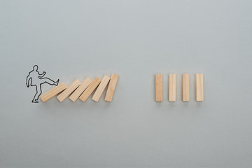 Wall Mural - top view of drawn man pushing wooden blocks on grey background, business concept