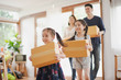 © linghaa - Young Asian family with daughter holds carton and walking in to a new home in moving relocation day which Excited smiling and felling happy. Mother Father and daughter move on a new home concept.