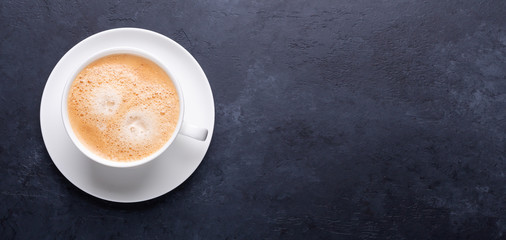 Cup of coffee on black stone background Top view Horizontal banner