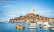 Scenic panoramic view of famous old town of Rovinj, a historic Mediterranean city in the north Adriatic sea, seen from busy tourist harbour area on a beautiful sunny day with blue sky, Istria, Croatia