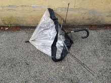 Broken Umbrella Abandoned On The Sidewalk